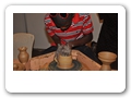 Exhibitors moulding local pots at the trade fair